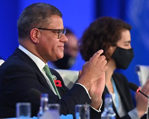 Britain's President for COP26 Alok Sharma (L) smiles as he makes his concluding remarks during the COP26 UN Climate Change Conference in Glasgow on November 13, 2021. (Photo by Paul ELLIS / AFP)